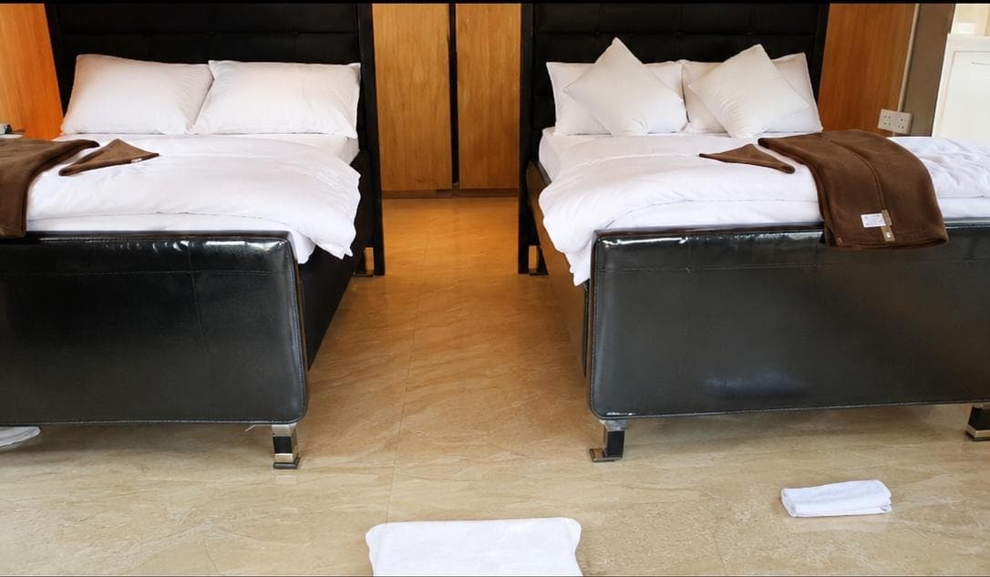 Twin bed accommodation with white linen at Rungwa North hunting camp, Tanzania