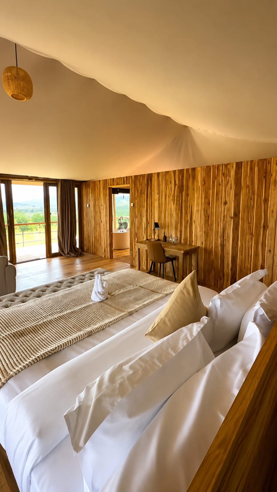 Luxury tented suite bedroom with hardwood interior and valley view, Rungwa North Tanzania
